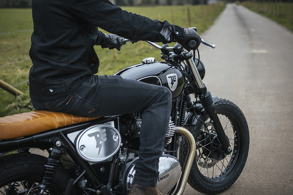 rider on custom royal enfield motorbike in wales